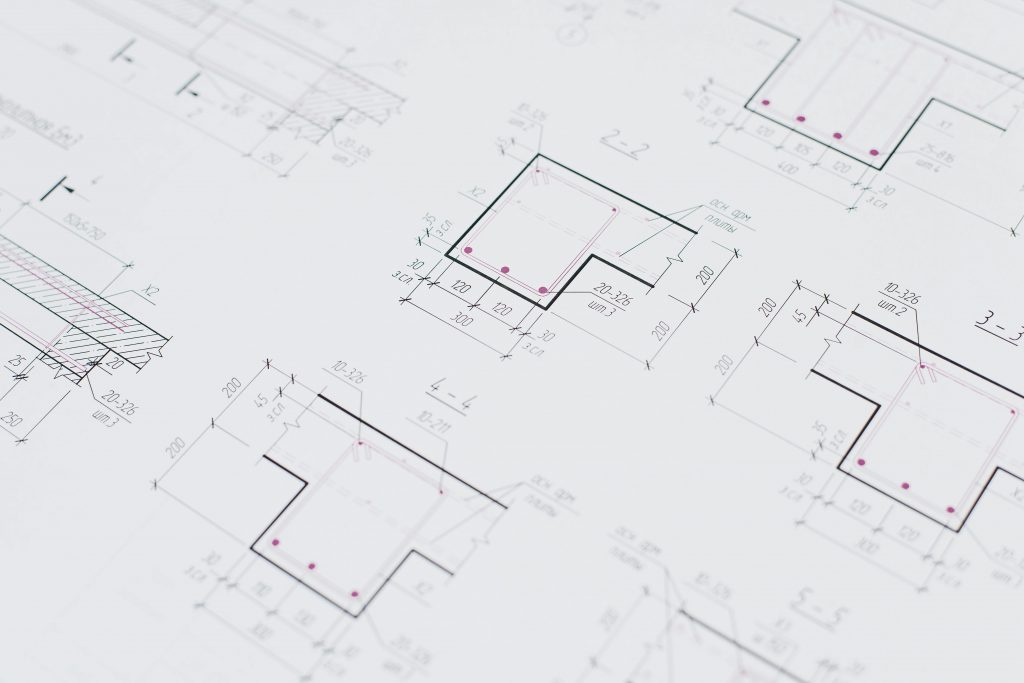 High-resolution close-up of detailed architectural blueprints showcasing precision design layouts.